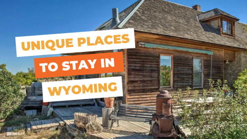 A rustic wooden house with a porch, surrounded by greenery, promoting unique stays in Wyoming.
