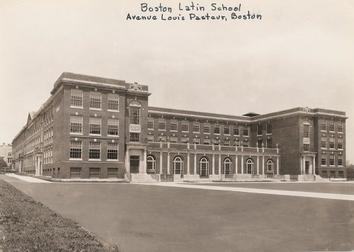 Historic black-and-white photo of Boston Latin School, showcasing its brick architecture and surrounding grounds.