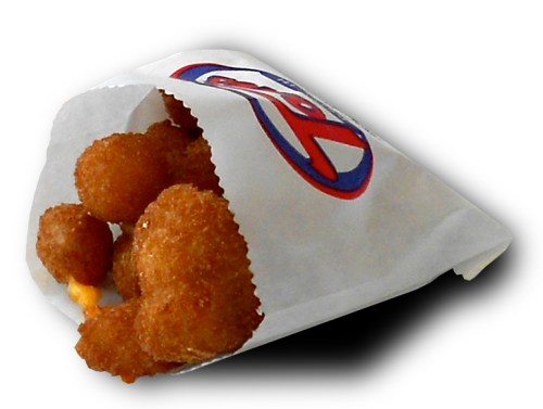 A paper bag containing golden, crispy cheese curds, partially visible.