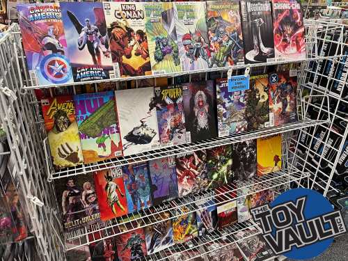 A display of various comic books on a wire rack, featuring superheroes and graphic novels.