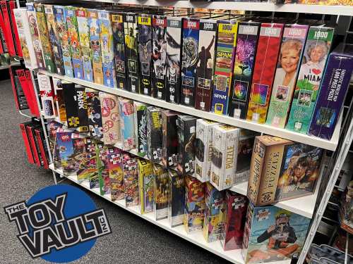 A shelf filled with various jigsaw puzzle boxes, featuring colorful designs and popular themes, in a toy store.