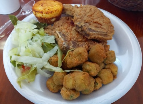A plate of fried chicken, fried okra, coleslaw, and a cornbread muffin.