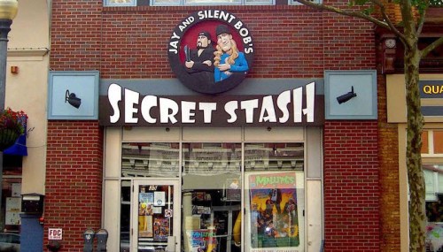 Storefront of "Jay and Silent Bob's Secret Stash," featuring a brick facade and colorful signage.