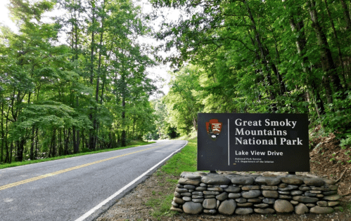 Sign for Great Smoky Mountains National Park along a tree-lined road, indicating Lake View Drive.
