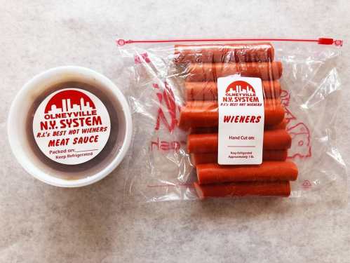 A container of meat sauce next to a bag of hot wieners, both labeled from Olneyville N.Y. System.