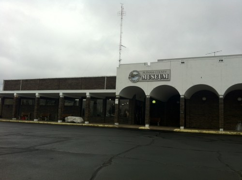 Exterior view of the Putnam County Museum, featuring a brick facade and arched entryway under a cloudy sky.