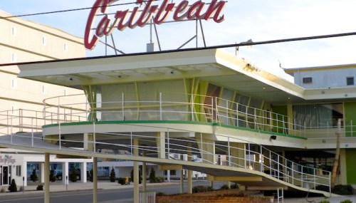 Mid-century modern motel with a distinctive sign reading "Caribbean" and a unique curved entrance ramp.