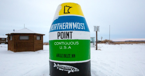 A large, colorful marker indicating the northernmost point of the contiguous USA in Angle Inlet, MN, surrounded by snow.