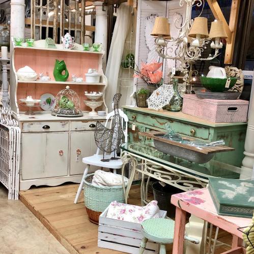 A cozy vintage display featuring pastel furniture, decorative items, and a mix of textures in a charming setting.