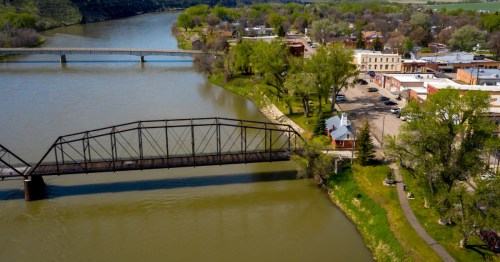 An aerial view of downtown Fort Benton, Montana, an old bridge, and the Missouri River.