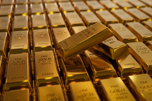 A close-up view of stacked gold bars, showcasing their shiny surfaces and engraved markings.