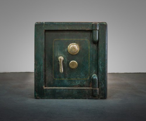 A vintage green safe with a round lock and a lever, set against a neutral background.