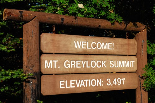 Wooden sign welcoming visitors to Mt. Greylock Summit, displaying an elevation of 3,491 feet.