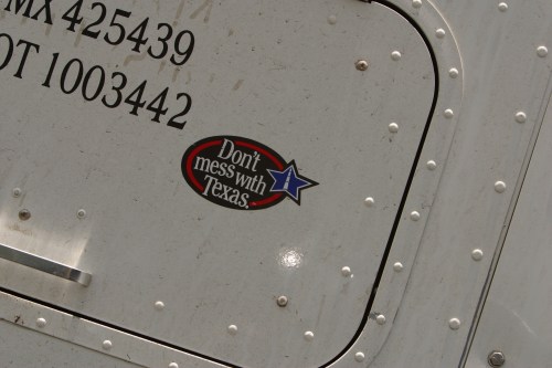 A close-up of a truck's side showing a "Don't mess with Texas" sticker with a blue star.
