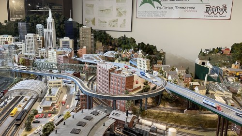 A detailed model city with buildings, roads, and trains, showcasing urban landscapes and miniature landscapes.