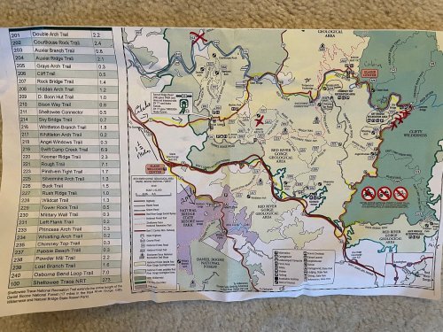 Map of hiking trails with marked routes, trail names, and points of interest in a natural area.