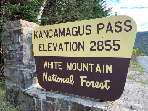 Sign for Kancamagus Pass, elevation 2855 feet, located in White Mountain National Forest.