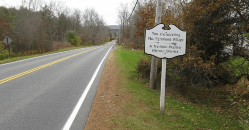 Sign marking the entrance to No. Egremont Village, a National Register Historic District, alongside a rural road.