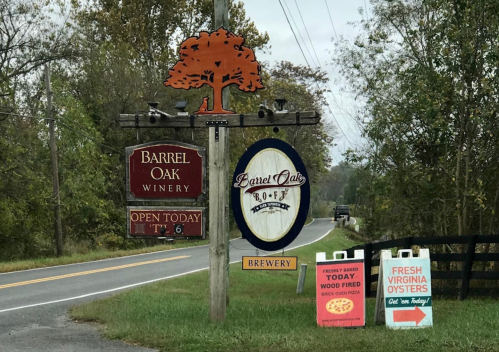 Signage for Barrel Oak Winery and Brewery, with directions and promotions for fresh oysters and wood-fired pizza.