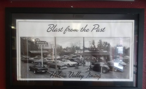 Black and white photo of vintage cars parked outside a drive-in, titled "Blast from the Past, Helena Valley Timing."