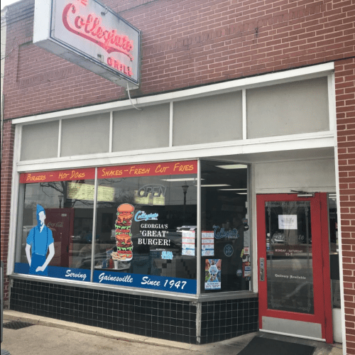 Exterior of a restaurant with a sign reading "Collinsville Grille," featuring a window display of burgers and fries.