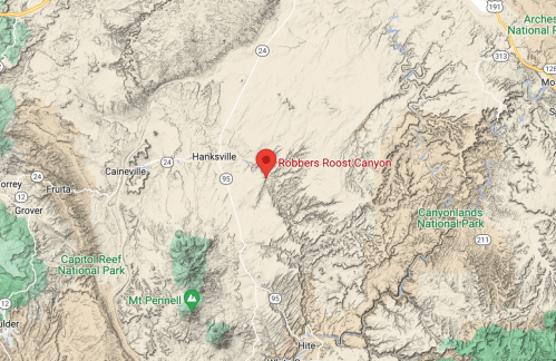Map showing Robbers Roost Canyon location near Hanksville, Utah, with surrounding national parks and highways.