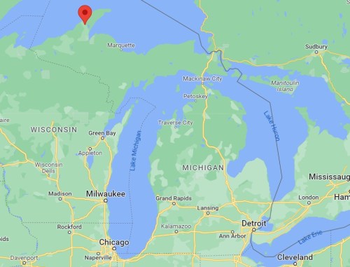 Map showing the northern part of Michigan, highlighting Marquette with a red marker.