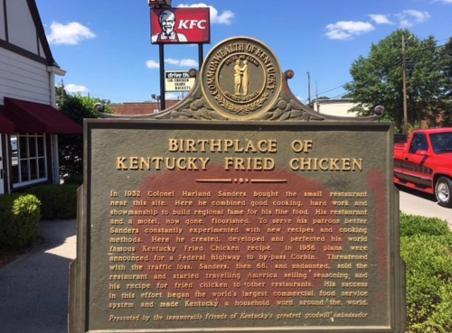 Historical marker detailing the birthplace of Kentucky Fried Chicken and its founder, Colonel Harland Sanders.