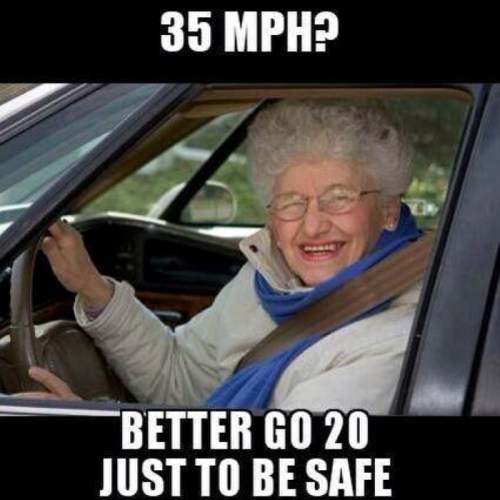An elderly woman smiles from the driver's seat, with a humorous caption about driving speed limits.