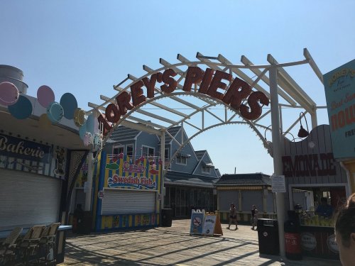 Entrance to Morey's Piers with colorful signage and a clear blue sky in the background.