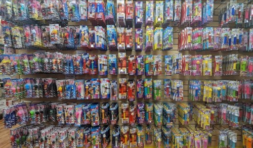A colorful display of various Pez dispensers arranged on a wall, showcasing numerous characters and designs.