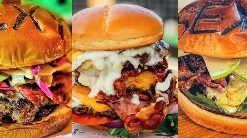 Three gourmet burgers stacked with various toppings, including bacon, cheese, and sauces, on toasted buns.