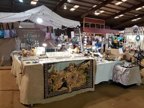 A vibrant market stall displaying a variety of jewelry and decorative items under a tent.