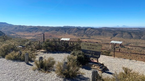 View of Five Points Vista in Lincoln National Forest, showcasing a vast desert landscape under a clear blue sky.