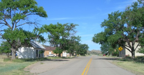 a street runs through the tiny remote town of kenton oklahoma on a sunny day