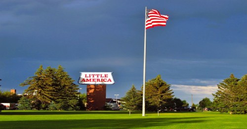 A large red and white sign with an American flag for Little America, a remote town in Wyoming.