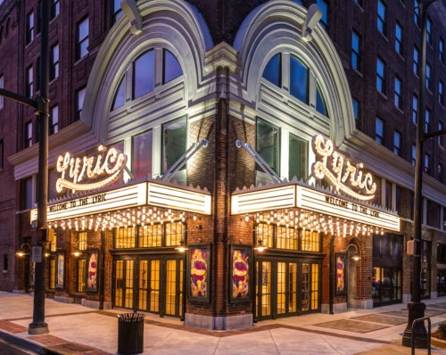 Historic Lyric Theatre exterior at night, featuring bright marquee lights and welcoming signage.