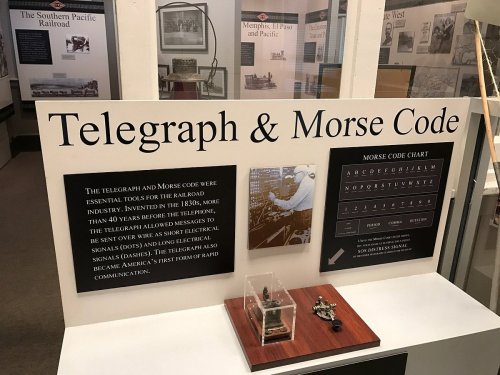 Display about the telegraph and Morse code, highlighting their importance in railroad communication and history.
