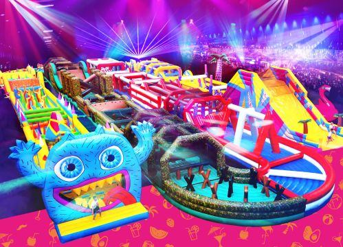 A vibrant inflatable obstacle course with colorful slides and structures, set in a lively, illuminated arena.