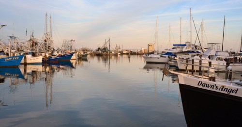 boats in the pass christian marina in mississippi at sunset