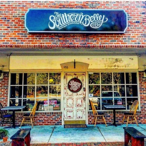 Exterior of "The Southern Belly BBQ" restaurant, featuring a brick facade, large windows, and a decorative sign.
