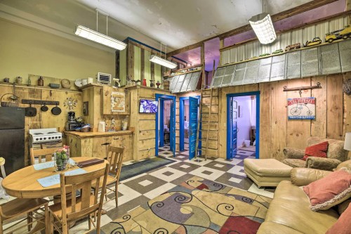 Cozy, rustic interior featuring a kitchen, dining area, and living space with wooden accents and colorful decor.