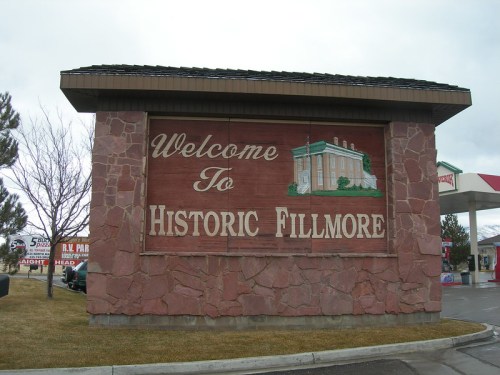 Welcome sign for Historic Fillmore, featuring a stone structure and decorative lettering.
