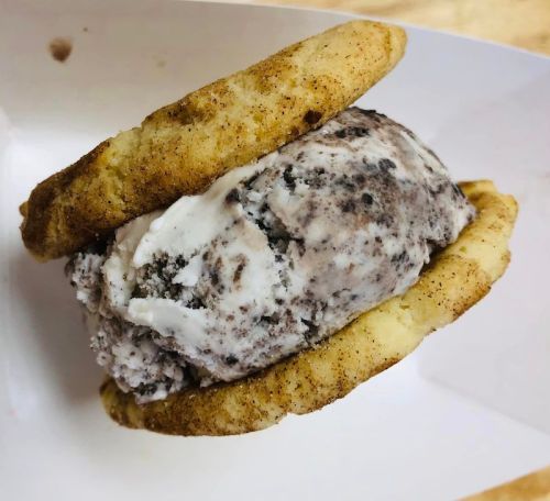 A delicious ice cream sandwich featuring cookies and cookies and cream ice cream.