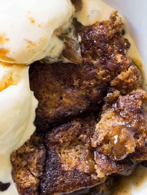 Warm dessert with a golden-brown crust, served with a scoop of vanilla ice cream melting on top.