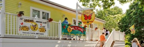 A bright yellow building with signs and people outside, promoting a restaurant called "The Original Morningside."