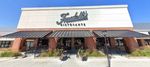 Exterior view of Fratelli's Ristorante, featuring a sign, awnings, and planters in front of a brick building.