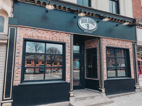Exterior of Building 9 Grille, featuring a brick facade, large windows, and a stylish sign above the entrance.