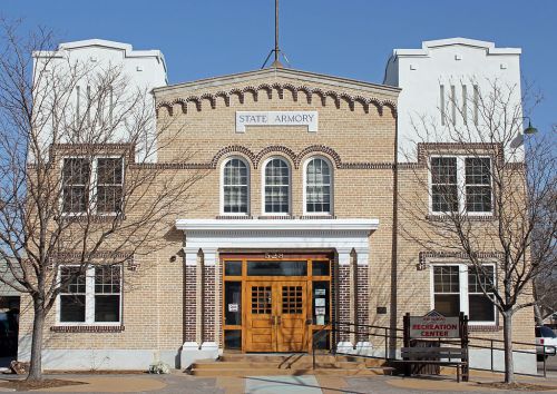Historic brick building with arched windows, featuring "State Armory" sign and "Recreation Center" entrance.