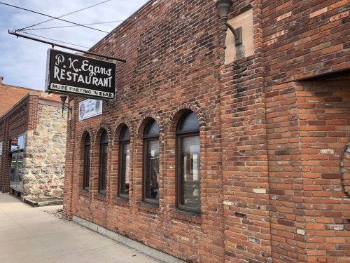 Exterior of P.K. Egans Restaurant, featuring a brick facade and arched windows, with a sign hanging above.